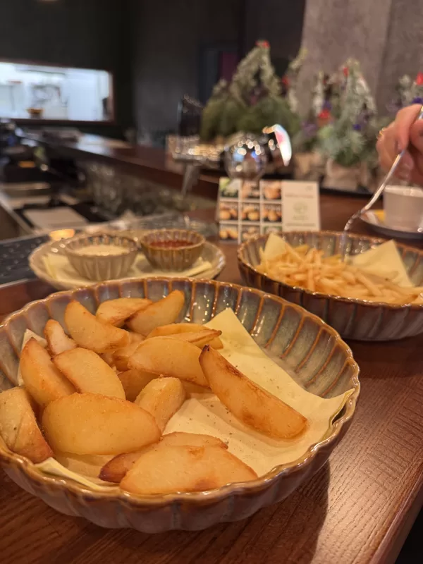 Kartupeļu šķirne 'Imanta', fritētas daiviņas, fonā fritēti stienīši. Restorāns "3sezonas"